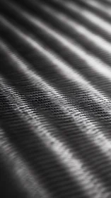 Carbon fiber surface shows diagonal weave and shallow depth