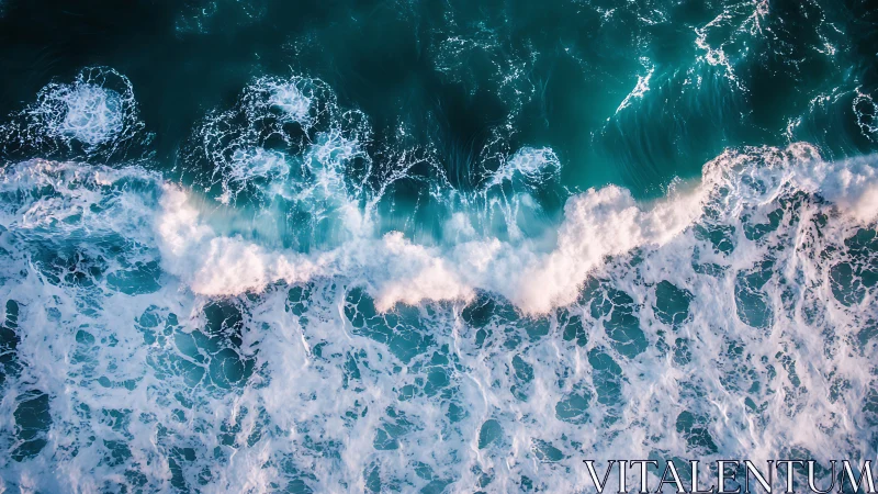 Aerial view of breaking turquoise ocean surf waves.