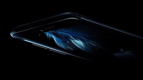 Sleek black smartphone with feather wallpaper in dramatic lighting.