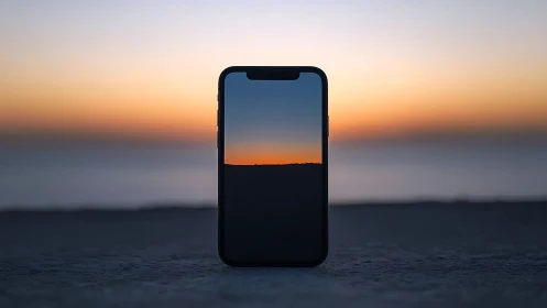 Phone portal frames a quiet seashore sunset horizon glow.