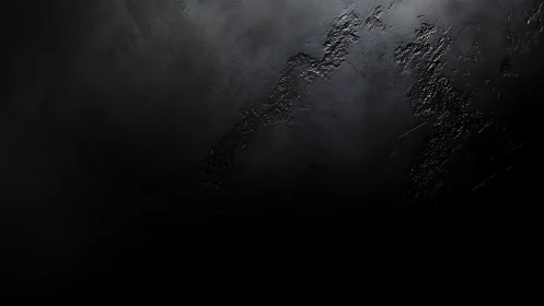 Moody textured black surface inviting quiet reflection.