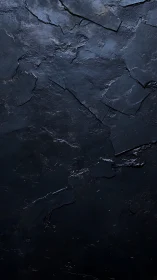 Dark slate stone texture with fractured layered surface.
