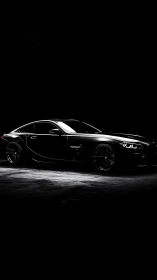 Black sports coupe in low key side profile lighting study.