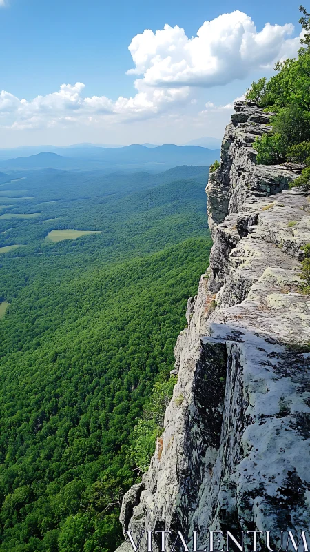 Sunlit mountain cliff overlooks endless green valley below