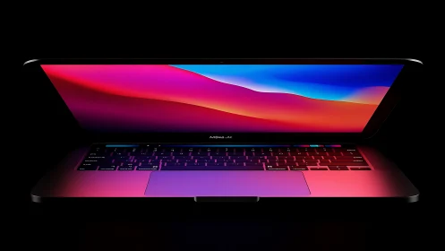 Half-open laptop glows with neon gradient display lighting