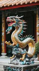 Ceramic dragon sculpture with gold scales at temple courtyard.