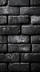Textured black brick wall with dramatic gritty patina.