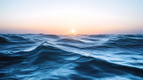 Sunlit ocean waves under soft pastel dawn horizon.