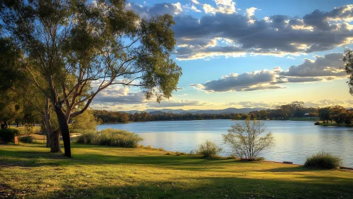 Golden hour lakefront landscape captures luminous clouds