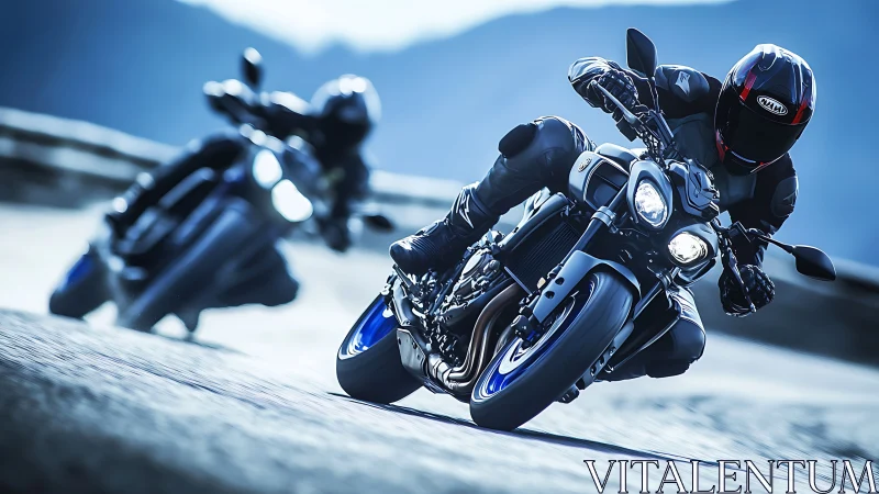 Two sport motorcycles corner on a mountain road at speed