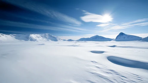 Snow-covered mountain plateau under clear winter sunlight.