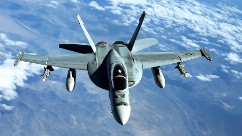 Modern military jet fighter flying high above clouds.