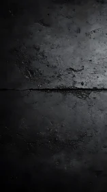 Low-key illuminated cracked asphalt surface textural study.