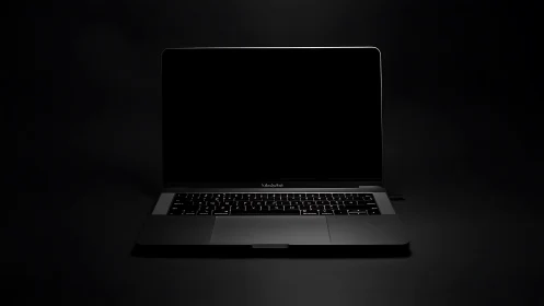 Closed-screen laptop computer on dark, low-key background.