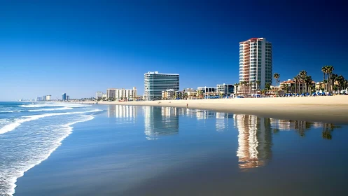 Sunlit beachfront skyline glows against a calm reflective shore