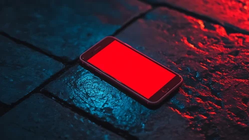 Glowing red smartphone against neon blue surface.