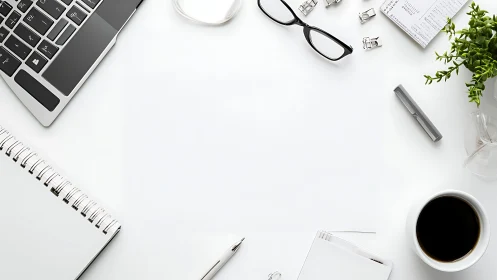 Minimal desktop with laptop, stationery and coffee mug.