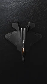 Stealth jet poised above dark ocean in quiet symmetry.