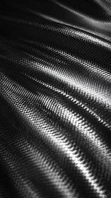 Macro view of reflective woven carbon fiber surface texture.