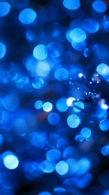 Blue defocused light orbs forming abstract bokeh field.