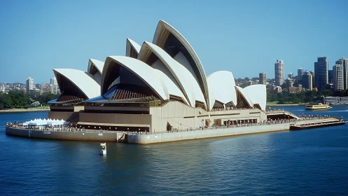 Segmented sail-shell roof structure dominates harbor-side podium