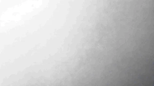 Soft gradient wall gently drifts from bright white to gray