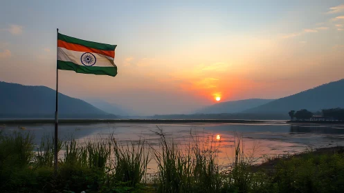 Photographic landscape of Indian flag by reflective lakeside at dusk.