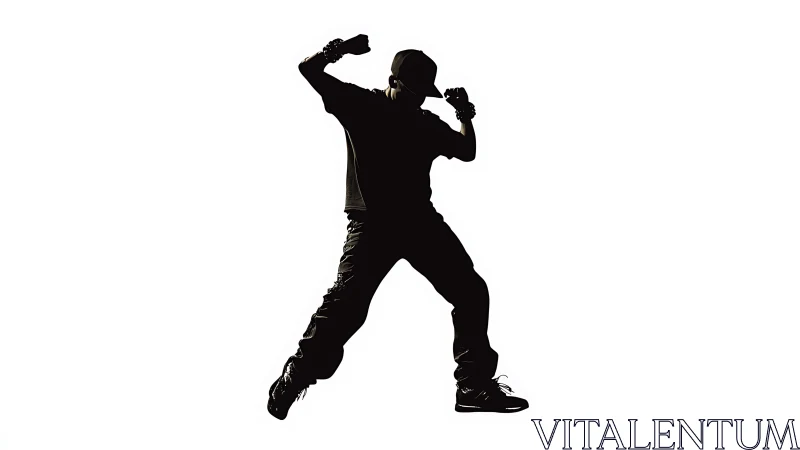 Silhouette shows a dancer frozen mid-jump on white background