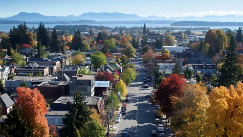 Colorful small town street unfolds toward distant blue mountains.