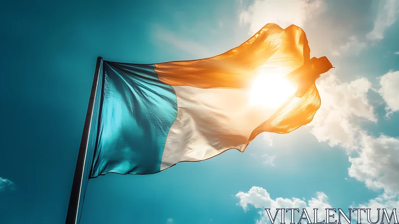Tricolour flag with teal, white, orange against sky.