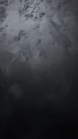 Textured graphite stormfield with stratified shadow gradients.