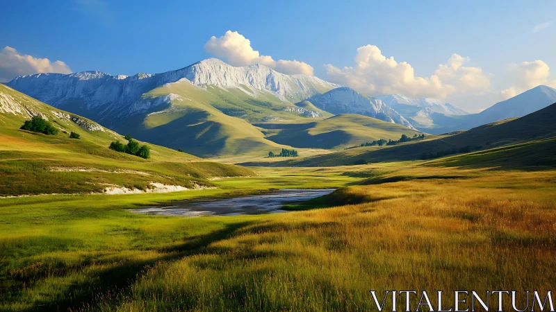Sunlit alpine valley cradled by luminous snowlit peaks.