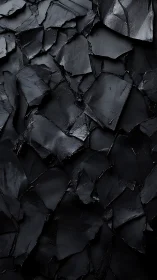 Layered black slate abstraction with fractured gloss planes.
