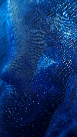 Textural blue mesh abstraction with luminous microstructure.