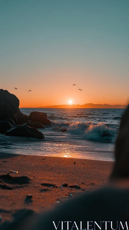 Golden sunset glows over tranquil waves on a rocky shore