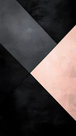 Diagonal geometric planes divide matte black and blush surfaces