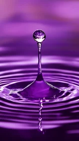Violet water droplet forms sculpted splash column.