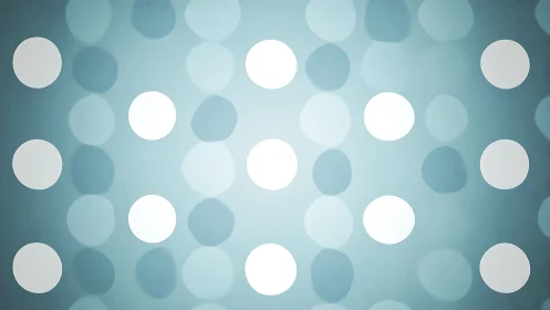 Soft teal bokeh circles form minimalist luminous pattern.