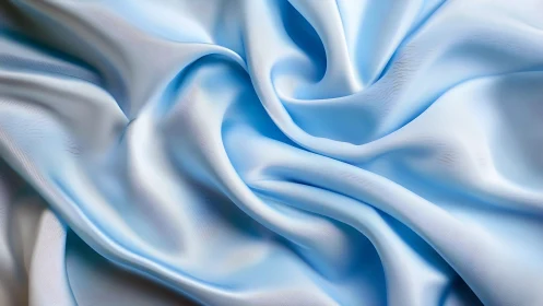 Flowing Blue and White Fabric Waves in Soft Light
