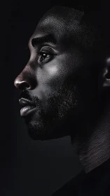 Side-lit male profile isolates sculptural facial structure