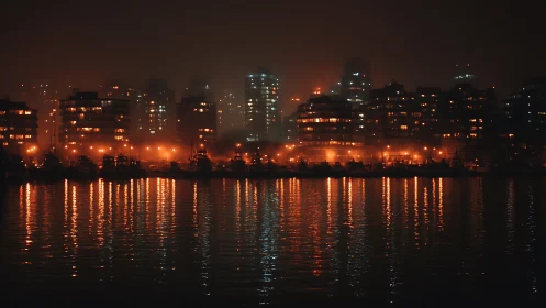 Harborfront city skyline glows through dense coastal fog.