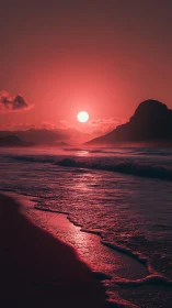 Red-toned coastal sunset with silhouetted headland and surf.