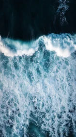 Cascading seafoam sketches lacework across midnight water