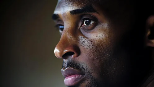 High-contrast close-up portrait isolates detailed skin texture