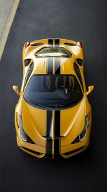 Top-down view of yellow striped sports car on dark asphalt.