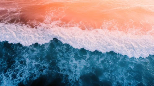 Sunlit surf glows softly where teal ocean meets peach sky