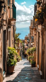 Sunlit Mediterranean alley cascading toward a distant sea.