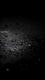 Macro gravel surface under dramatic low key light.