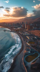 Coastal city skyline at sunset with waves and beachfront.