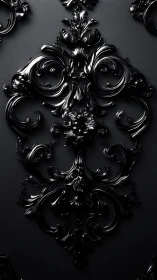 Baroque black ornamental relief on dark textured wall.